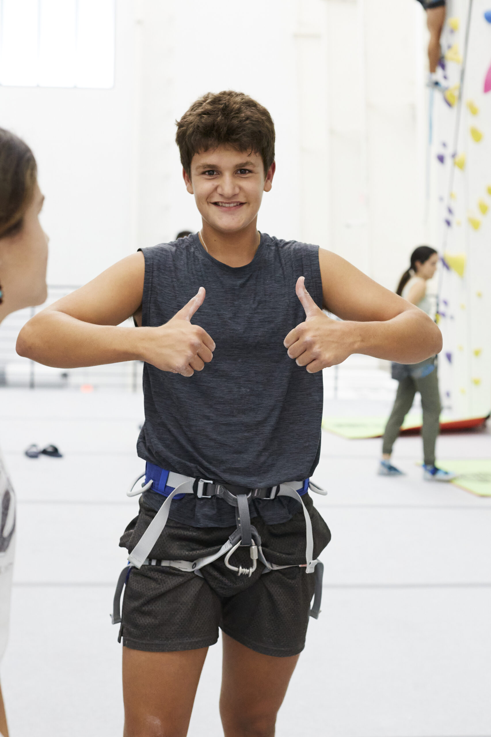 Climber at Velocity Climbing wearing essential rock climbing gear